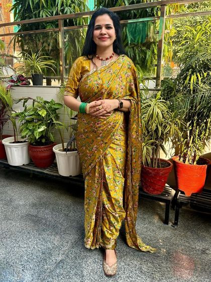 This dhoti-style saree in a beautiful mustard yellow is such a unique and stylish outfit. It's a modern take on the traditional saree and perfect for making a statement at a festive gathering.