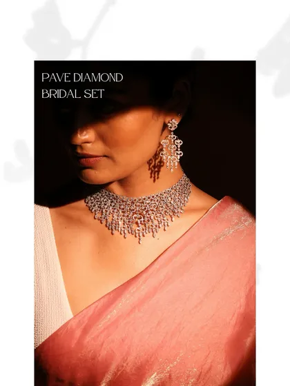 This Pave Diamond Bridal Set offers a breathtaking display of pure brilliance. Worn here, the necklace and earrings create a cohesive look of cascading light, perfect for a glamorous bridal statement.