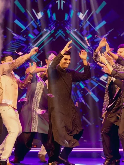 The groom celebrating on stage with his friends during the Sangeet performance. These candid moments of joy are what make the night truly special.