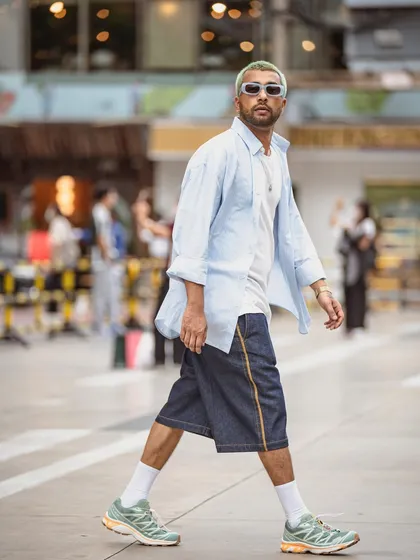 A full-body shot showing the complete outfit, from the shirt to the sneakers.