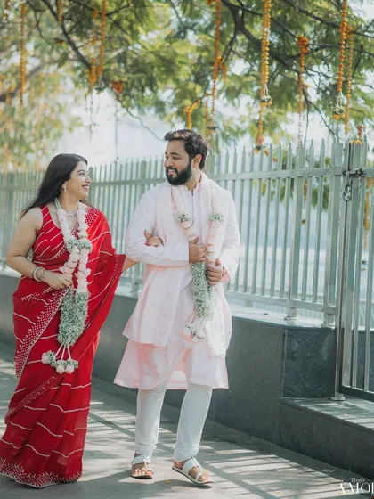 The newly married couple taking a walk after their court ceremony. Dressed in simple yet elegant attire, their happiness is the main focus of this beautiful, sunlit shot.