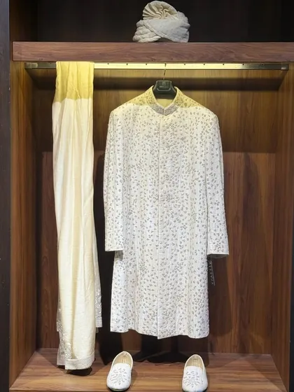 For the discerning groom, the wedding day is a defining moment. I create bespoke wedding couture, like this intricately detailed sherwani, that blends heritage with minimalist elegance. Every stitch is a promise of perfection for your most important celebration.