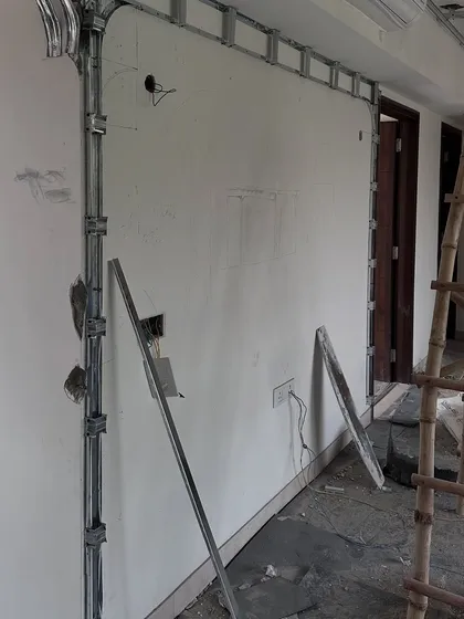The living area of 'Project Lily' during construction, with framework for the false ceiling and wall treatments being installed.