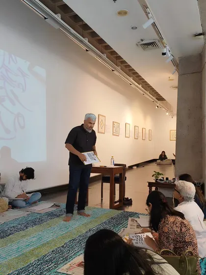 An instructor guides participants during a hands-on calligraphy session in our gallery. Our workshops provide direct access to talented artists and experts.