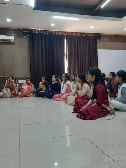 Students listening intently as Guru Maa Smt. Ruby Mishra shares her knowledge during the 'Sadhana Mahotsav' workshop.