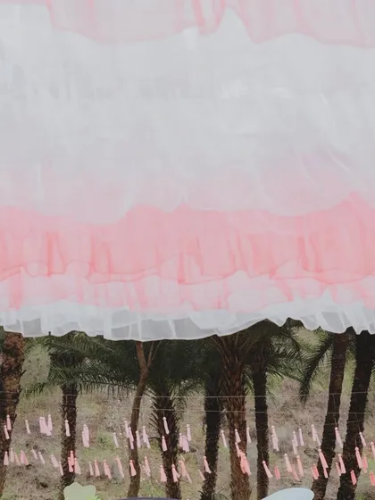 A close-up of the ruffled pink and white ceiling drapes that created a dreamy canopy over the 'Sunny Sway Soirée'.