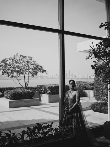A stunning black and white portrait of the bride against the Mumbai skyline. The contrast and composition create a dramatic and sophisticated image.
