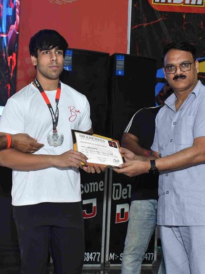 Another shot of our young champion, Yash, receiving his medal. His dedication to the sport of powerlifting, combined with our professional training, has propelled him to greatness.