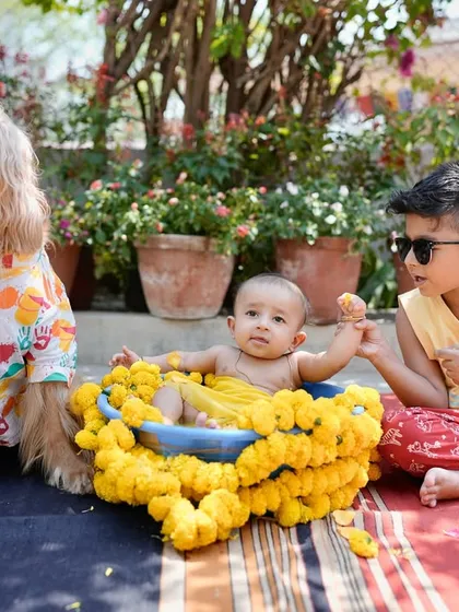 The brothers together during the 'gaye holud' ceremony. Posto watching over Pablo in his flower-filled tub.