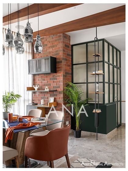 This view shows the material palette of Apartment 704, with a raw brick wall, a dark green powder room partition, and wooden ceiling beams. The design is a fusion of rustic elements and sleek, modern lines.
