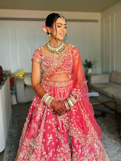 A full-length view of the bride. The hairstyle is balanced and proportionate, complementing her entire bridal outfit from head to toe.