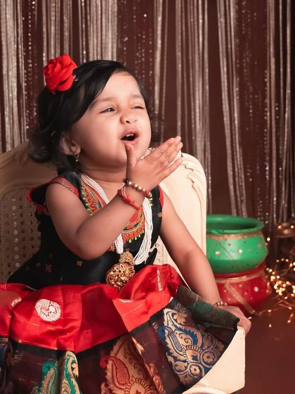 A sweet, contemplative expression. Even the quiet moments are beautiful, especially in a setting as rich and colorful as this traditional-themed shoot.