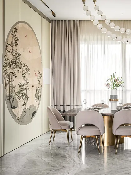 A full view of the dining setup in our 2,700 sq.ft. project. The round marble table, blush-toned chairs, and bubble chandelier create an elegant and modern space for gathering. The large windows provide a stunning city backdrop.
