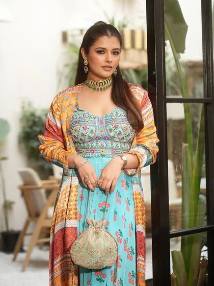 Shine from every angle. This beautiful potli features mirror work, metallics, and artisanal flair in one elegant silhouette, perfect for cocktail nights and sangeet events.