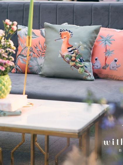 A close-up of the custom cushions and floral arrangements in 'The Conservatory' lounge.
