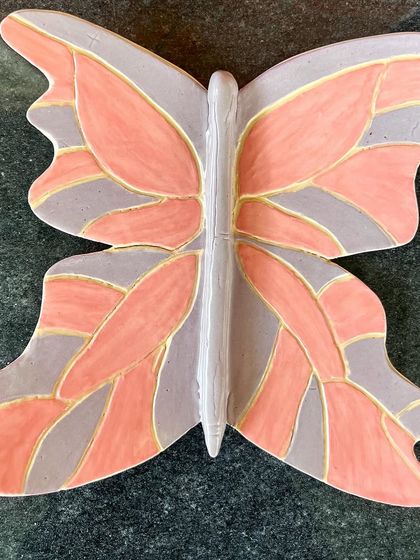 A beautiful, hand-painted butterfly wall decor piece, created by a student.