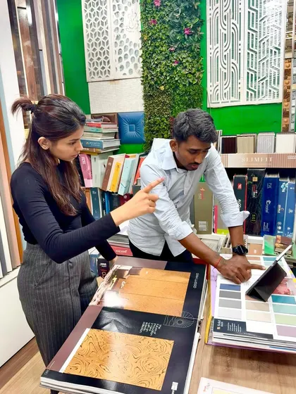The design process is a partnership. Here, I am with a client in a showroom, reviewing digital mockups on a tablet and selecting the perfect laminates and finishes that match their vision.