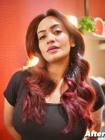 The "After" shot of this stunning red transformation. The color is vibrant and the hair looks healthy and full of life, a testament to using professional-grade products and techniques.