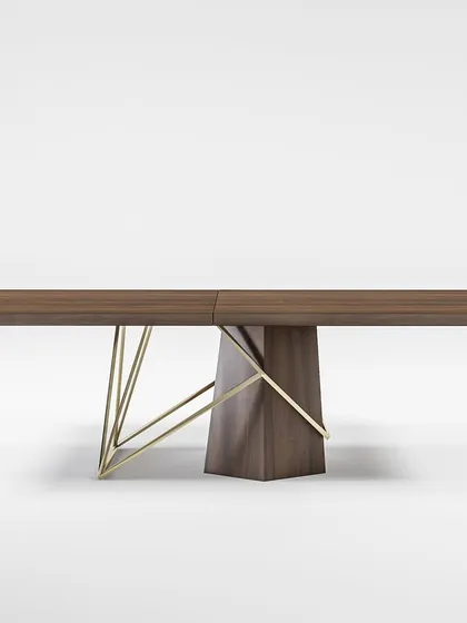 A frontal view of the dining table, showcasing its expansive wooden top and the perfect symmetry of its modern, sculptural base.