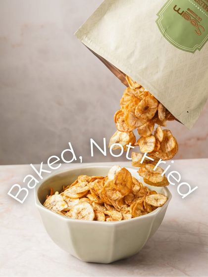Baked, not fried. My Masala Banana Chips are seen pouring into a bowl, highlighting their light and crispy texture. This is healthy snacking made easy and delicious.