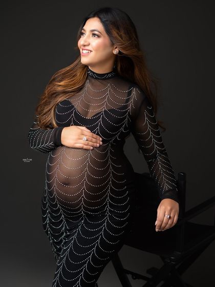 A close-up shot capturing the beautiful smile and glowing skin of this mamma-to-be in her unique and glamorous gown.