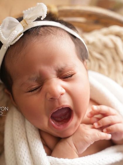 A perfectly timed capture of a big newborn yawn. These are the authentic, unscripted moments that add so much personality to your baby's first portraits.