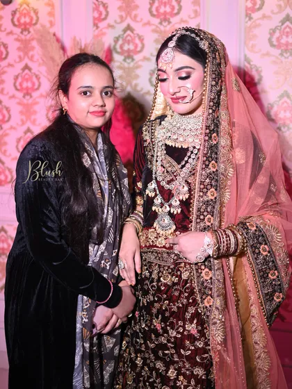 Another successful student with her model, showcasing a deep velvet lehenga look with dramatic makeup.