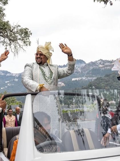 The groom's grand baraat entry in a vintage car, winding through the hills of Mussoorie. Capturing the journey is as important as the destination.