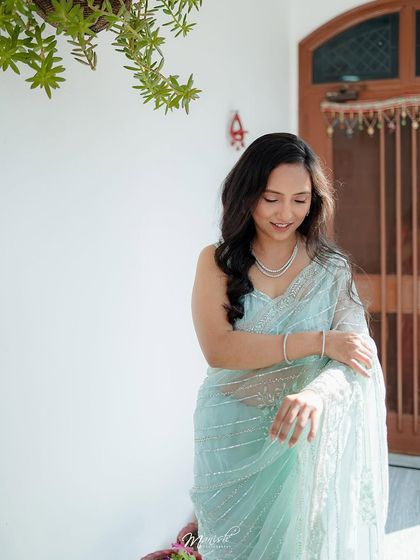 A beautiful solo portrait of the bride-to-be, looking elegant and serene in her lovely pastel saree.