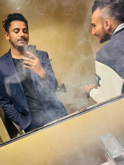 A mirror selfie with a friend. We're the real deal, and we're here to take over.