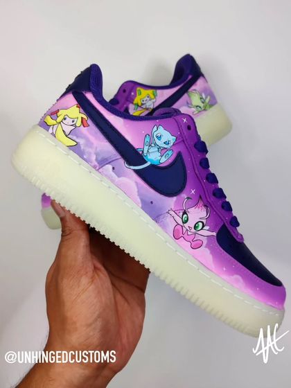 A mythical Pokémon themed Air Force 1 with a dreamy, cosmic background. This side features the adorable Jirachi and Mew against a purple and pink nebula.