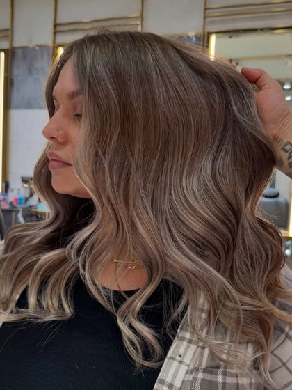 A close-up of the creamy vanilla blonde balayage, showing the seamless transition from darker roots to lighter ends.