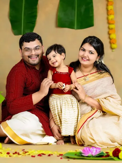 A beautiful family celebrating Onam. Their coordinated traditional outfits and happy smiles create a perfect festive family portrait.