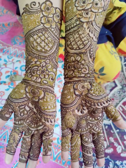 A close-up of a detailed palm design, featuring intricate floral work and fine-line details.