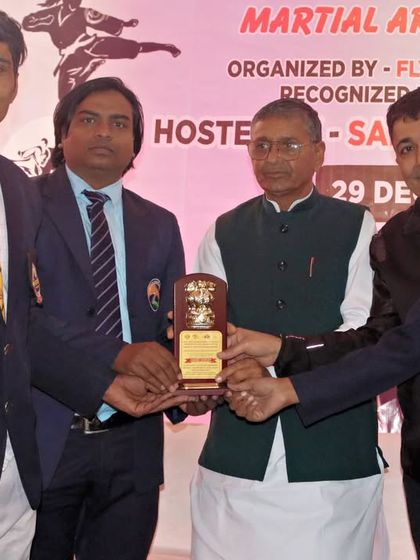 Receiving an award at a Martial Art Championship. These moments are a result of years of discipline and training, both for me and my students.