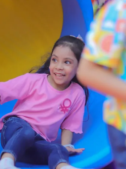 A happy smile from a child enjoying the slide. Our equipment is well-maintained to ensure a smooth and enjoyable ride every time.