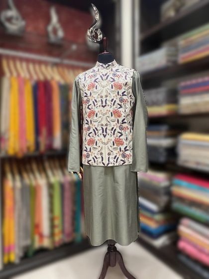 Wear your heart on your sleeve, or rather, on your jacket. This stylish kurta pajama set features an intricately embroidered jacket.