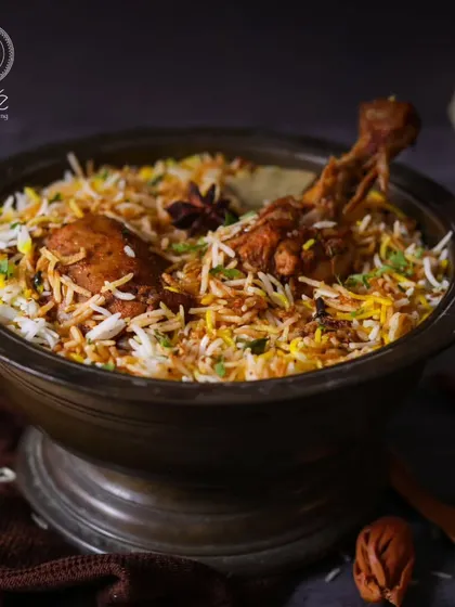 A rich and aromatic Chicken Biryani, cooked with long-grain basmati rice and fragrant spices. This dish is an epitome of luxury, meticulously crafted by our culinary maestros for an unmatched dining sensation.