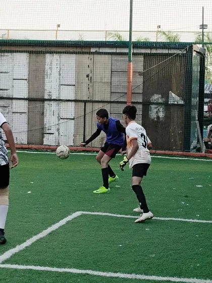 Here is a glimpse of our players in the middle of a competitive match during the Peace Soccer Cup. This image captures the intensity and focus we instill in our athletes as they challenge an opponent for ball possession on the turf.