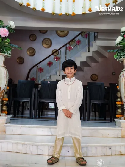 A simple yet elegant off-white kurta set, perfect for daytime events or pujas. This shows our range from grand sherwanis to understated, classic ethnic wear for boys.