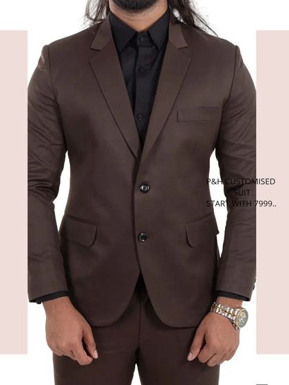 A close-up torso shot of the brown suit, showing the two-button jacket and notch lapels.