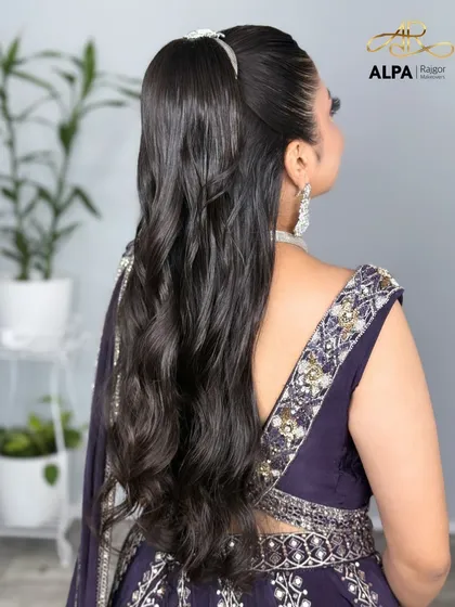 A side view of the high ponytail with soft waves, adding movement and style.