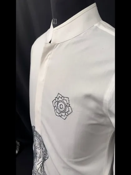 A side view of the abstract figure shirt, highlighting the clean mandarin collar and the placement of the geometric floral embroidery.