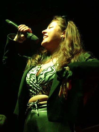 A candid shot capturing a moment of pure joy while hosting on stage. I truly love what I do, and I think it shows.