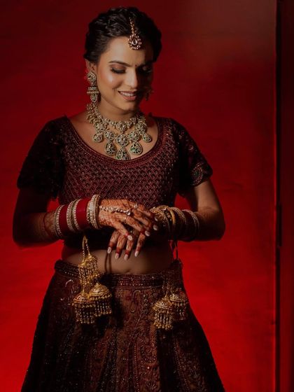 A beautiful candid shot of the bride, Shubhangi. The lighting highlights the glow on her skin and the intricate details of her bridal look.