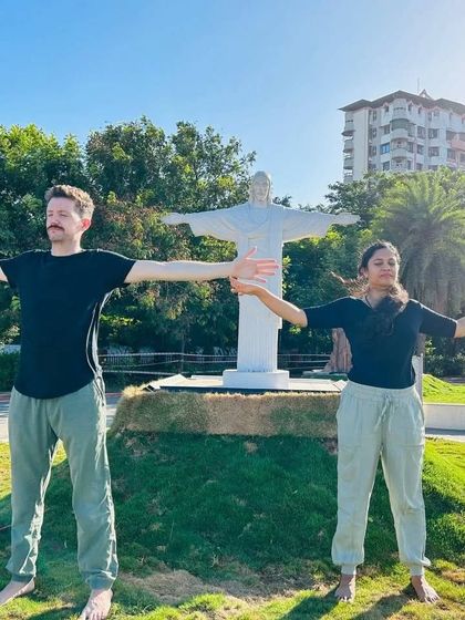 A moment of practice in front of a miniature Christ the Redeemer statue. Yoga transcends all cultures and beliefs, offering a path to inner well being for anyone who is willing.