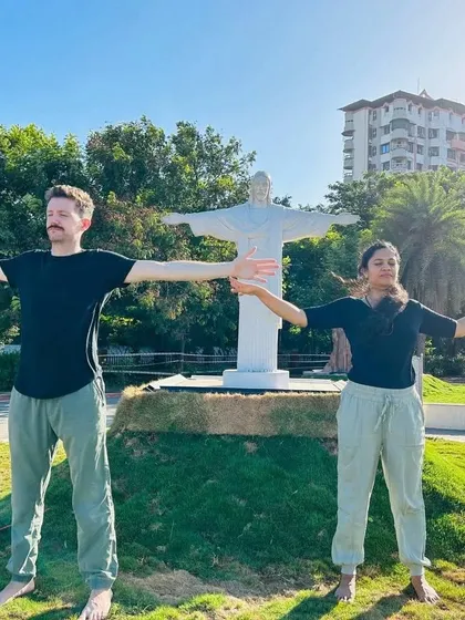 A moment of practice in front of a miniature Christ the Redeemer statue. Yoga transcends all cultures and beliefs, offering a path to inner well being for anyone who is willing.