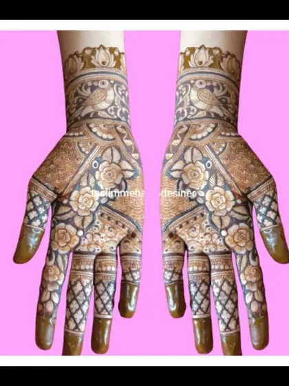 A gorgeous design featuring roses and birds within a geometric layout. The checkered pattern on the fingers adds a classic touch to this intricate piece.