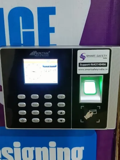 A close-up of the Realtime biometric machine at Anshika Institute. The device features both a fingerprint scanner and an RFID card reader, offering multiple ways for staff and students to gain access.