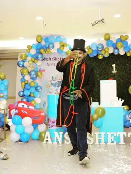 The classic linking rings trick in action during a lively birthday celebration. This illusion is a crowd favorite that gets everyone wondering, "How did he do that?"